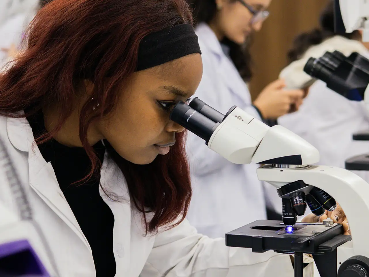 student-looking-through-a-microscope
